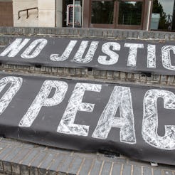 Signs read "No Justice, No Peace" at a Black Lives Matter march. Protesting can bring up old traumas...