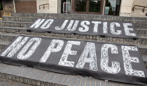 Signs read "No Justice, No Peace" at a Black Lives Matter march. Protesting can bring up old traumas...