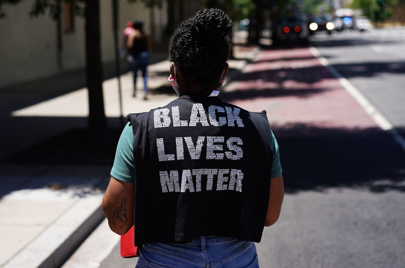 A woman wears a Black Lives Matter shirt. Self-care before protests can involve meditation, rituals,...