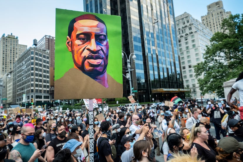 A painted portrait of George Floyd is held aloft at a protest. How To Handle Emotional Burnout As Yo...