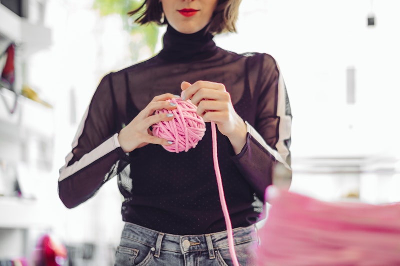 A woman knits from a big pink ball of yarn. People Are Making Instagram Accounts To Show Off Their N...