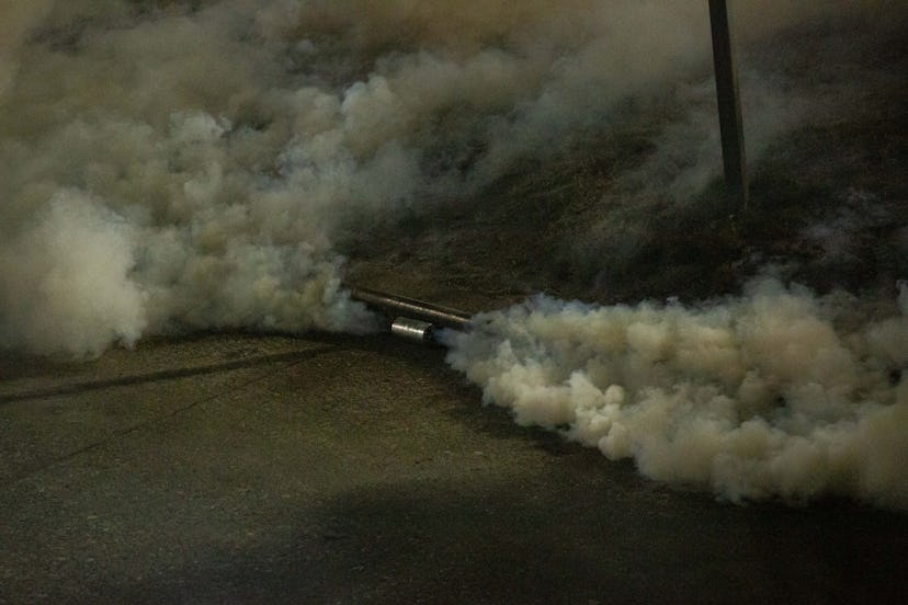 A tear gas canister emitting spray. We asked doctors how tear gas can affect your period.