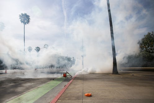 Tear gas in an empty street during Black Lives Matter protests. Can Tear Gas Affect Your Period? Doc...