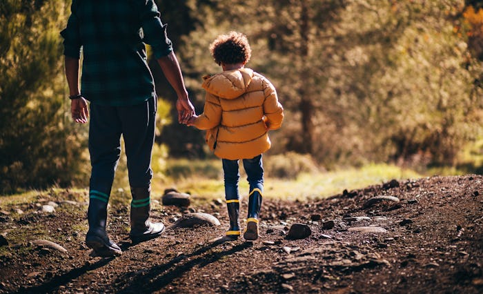 A dad and a kid in a walk in the nature staying away from ticks
