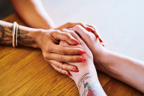 Two women's hands close up. PTSD, or post-traumatic stress disorder, can affect memory in multiple w...