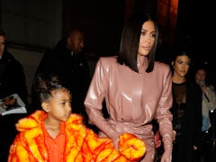 Kim Kardashian steps out in a latex bodysuit with daughter North West.