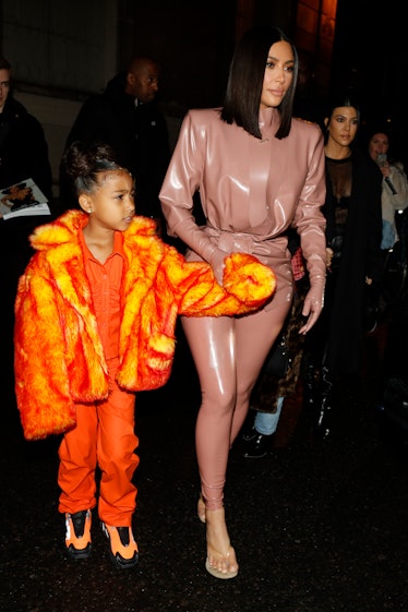 Kim Kardashian steps out in a latex bodysuit with daughter North West.