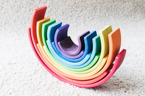 A rainbow children's toy on a white carpet. How 6 LGBTQ People Are Celebrating Pride During Social D...