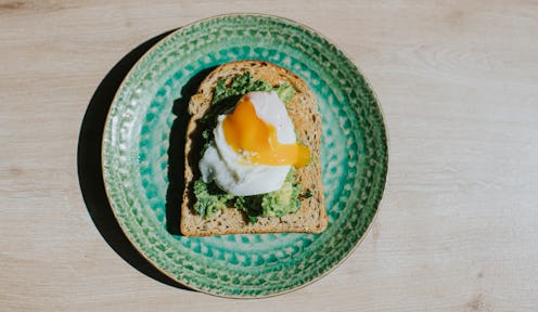 An avocado toast with an egg on it. The Gen Z Vs. Millennials Viral Beef Explained By Gen Z-Millenni...