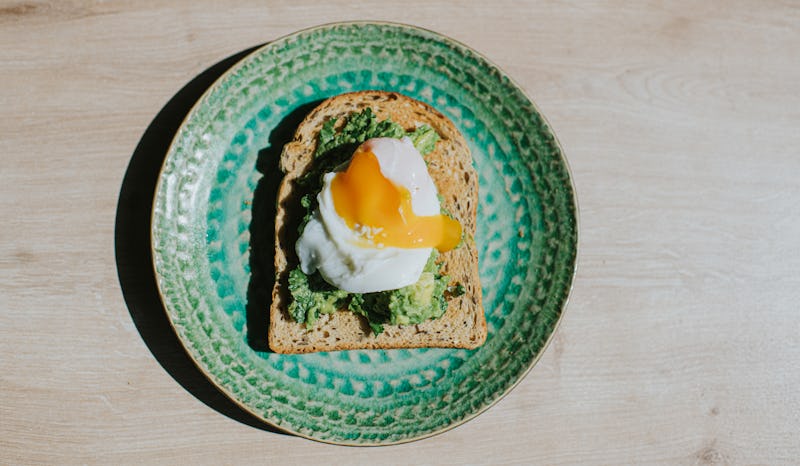 An avocado toast with an egg on it. The Gen Z Vs. Millennials Viral Beef Explained By Gen Z-Millenni...