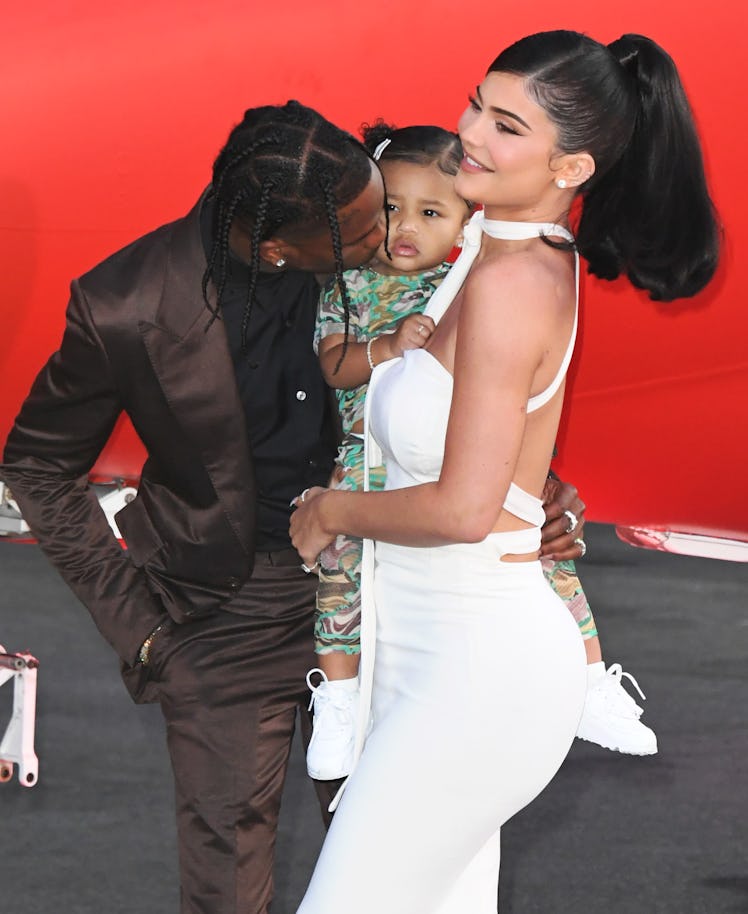 Travis Scott gives daughter Stormi a smooch.