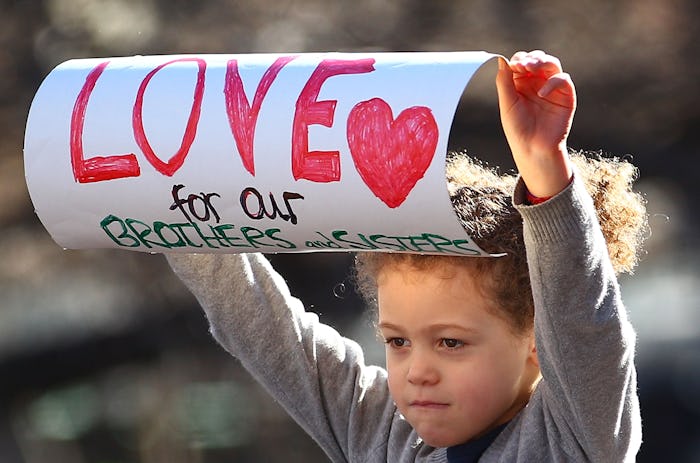 little girl holding sign at black lives matter demonstration