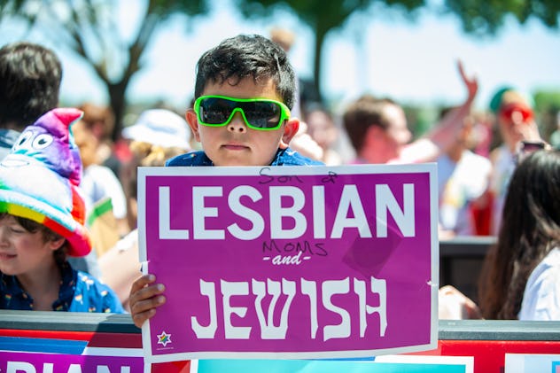 Young boy holds sign