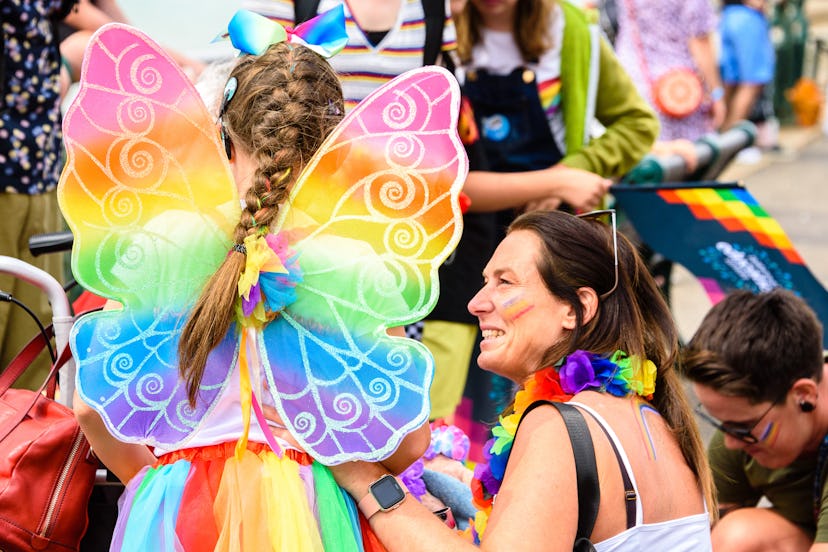 A girl in a butterfly costume celebrates Pride