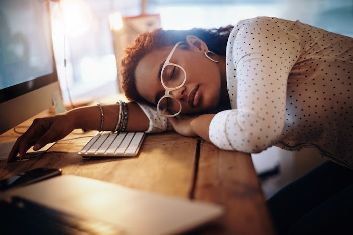 woman sleeping on desk