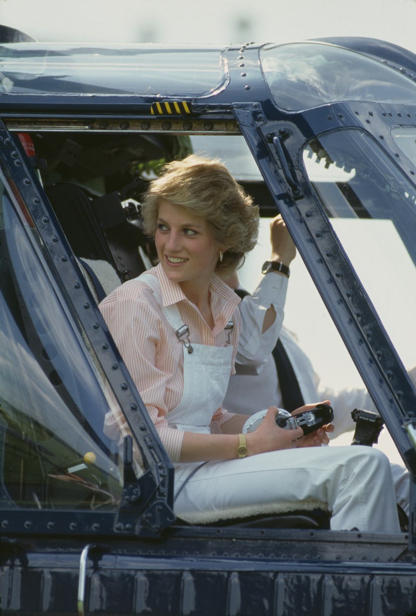 Princess Diana wears white overalls on a helicopter ride