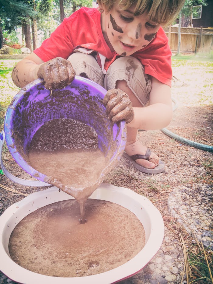 boy playing with mud