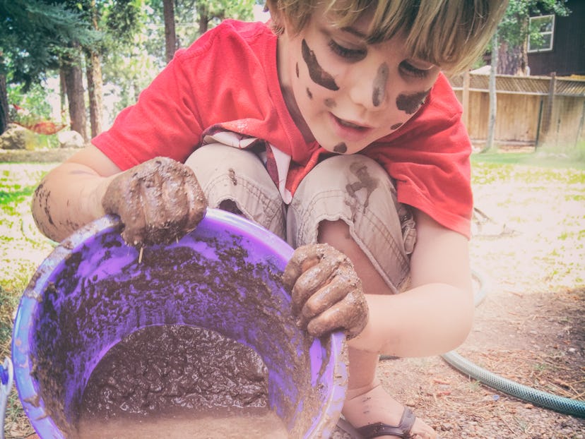 boy playing with mud