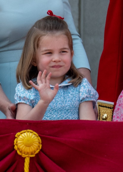 Princess Charlotte waves in a red hairbow