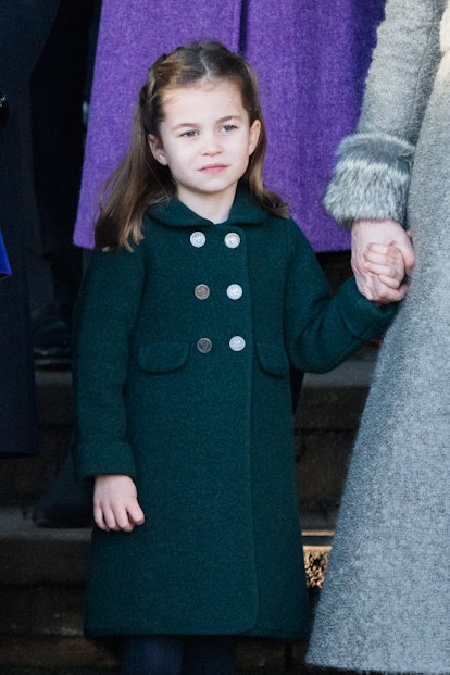 Princess Charlotte stands in a green coat