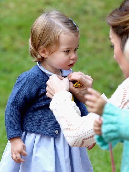 Kate Middleton buttons Charlotte's cardigan 