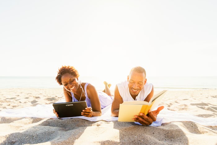 couple reading books on beach