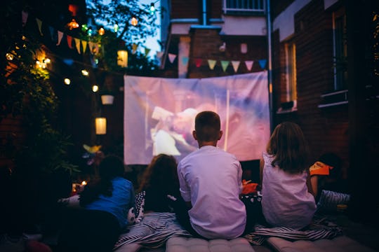 family having backyard movie night