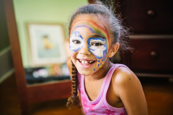 little girl with rainbow face paint