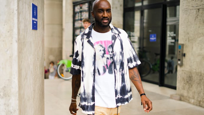Virgil Abloh in a white black shirt, white t-shirt and beige pants