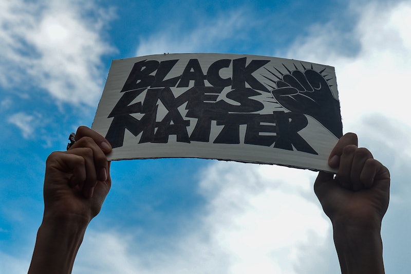 A woman marches in a Black Lives Matter march. Confronting racism online isn't just the duty of peop...