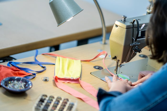 woman sewing face mask