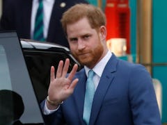Prince Harry waves to royal fans.