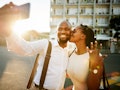 A young couple takes a picture during golden hour after getting engaged.