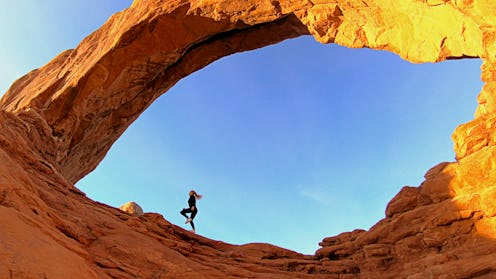 A woman runs inside a desert rock formation. Experts weigh in on ways to run better in the heat.