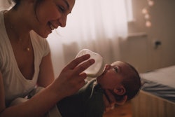 mom feeding infant with bottle