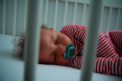 Baby sleeping in crib, in a story answering the question, will white noise machines affect toddler s...