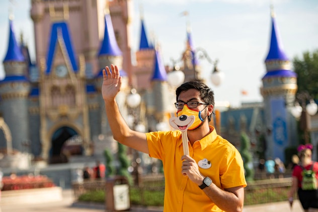 A Disney cast member holds up a smile. 