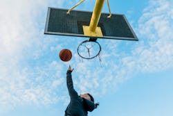 A person throws a basketball. These are team sports you can play by yourself during quarantine.