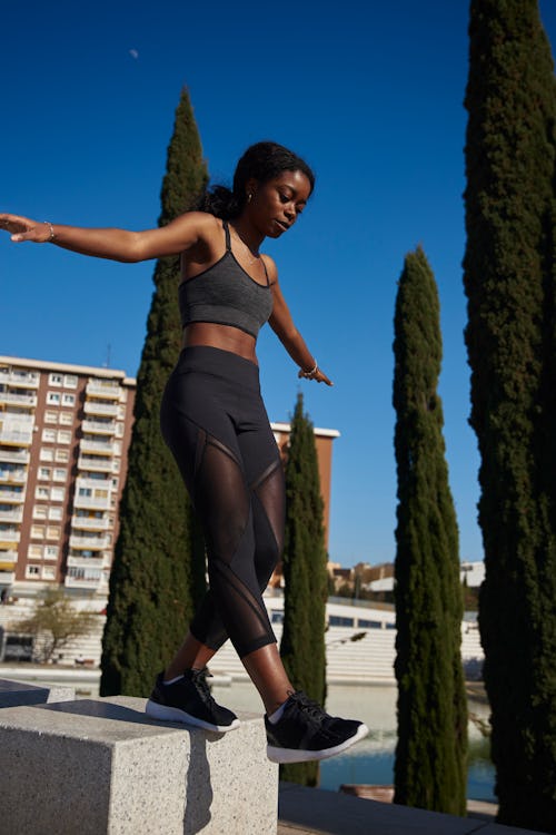 A woman walks wearing athletic gear. People are going viral on TikTok for walking marathons.