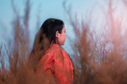 A woman looks into the distance. Envy can involve many different brain regions.
