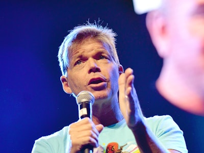 Rob Liefeld holding a microphone while speaking about Deadpool 3