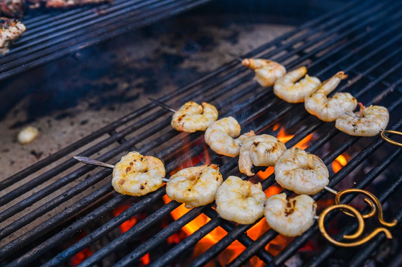 garlic grilled shrimp getting grilled on a fire