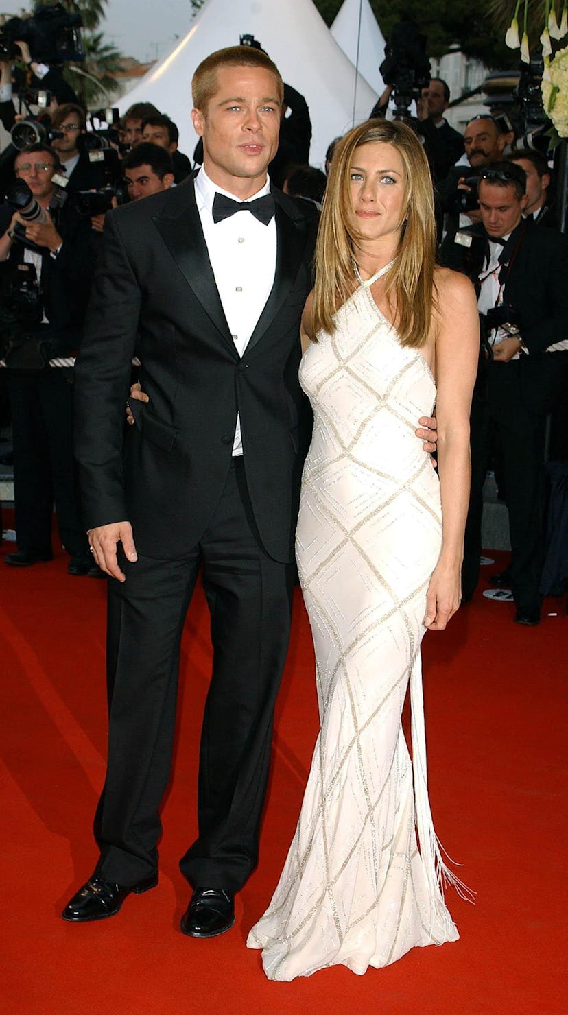 Jennifer Aniston wearing a white and gold halter neck Versace dress at the 2004 Cannes Film Festival...