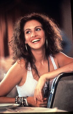 Julia Roberts with a curly hair, wearing a white tank top, smiling