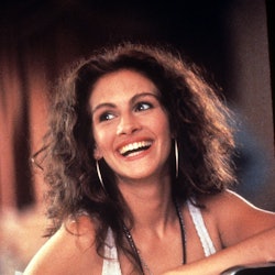 Julia Roberts with a curly hair, wearing a white tank top, smiling