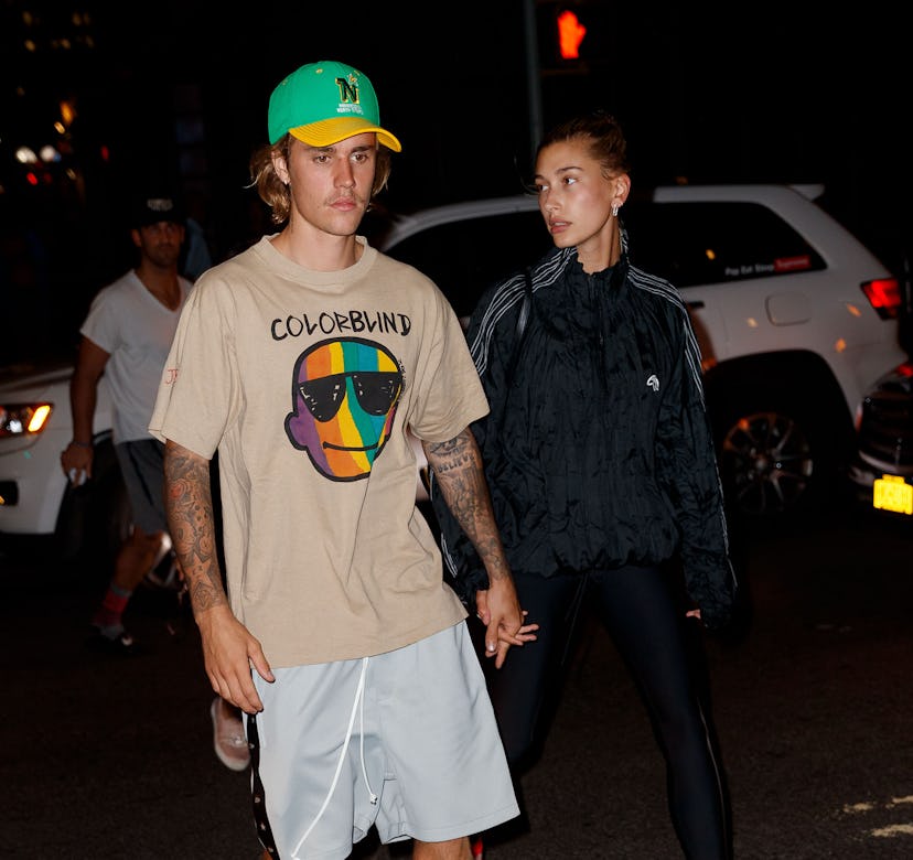 Justin Bieber and Hailey Bieber holding hands.
