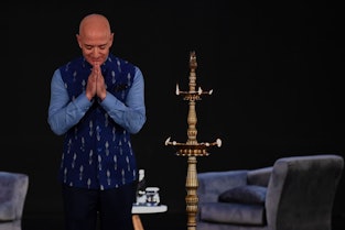 Jeff Bezos bows on stage during a trip to India. 
