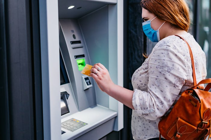 woman in face mask at atm