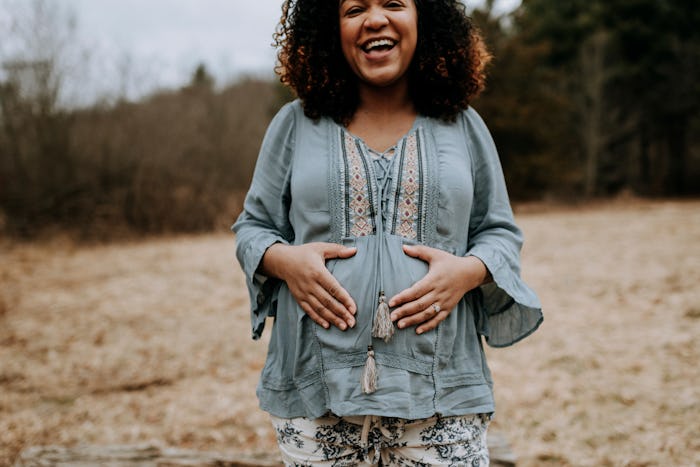 pregnant woman outside laughing