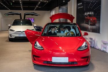 A Tesla Model 3, with a Model X behind.